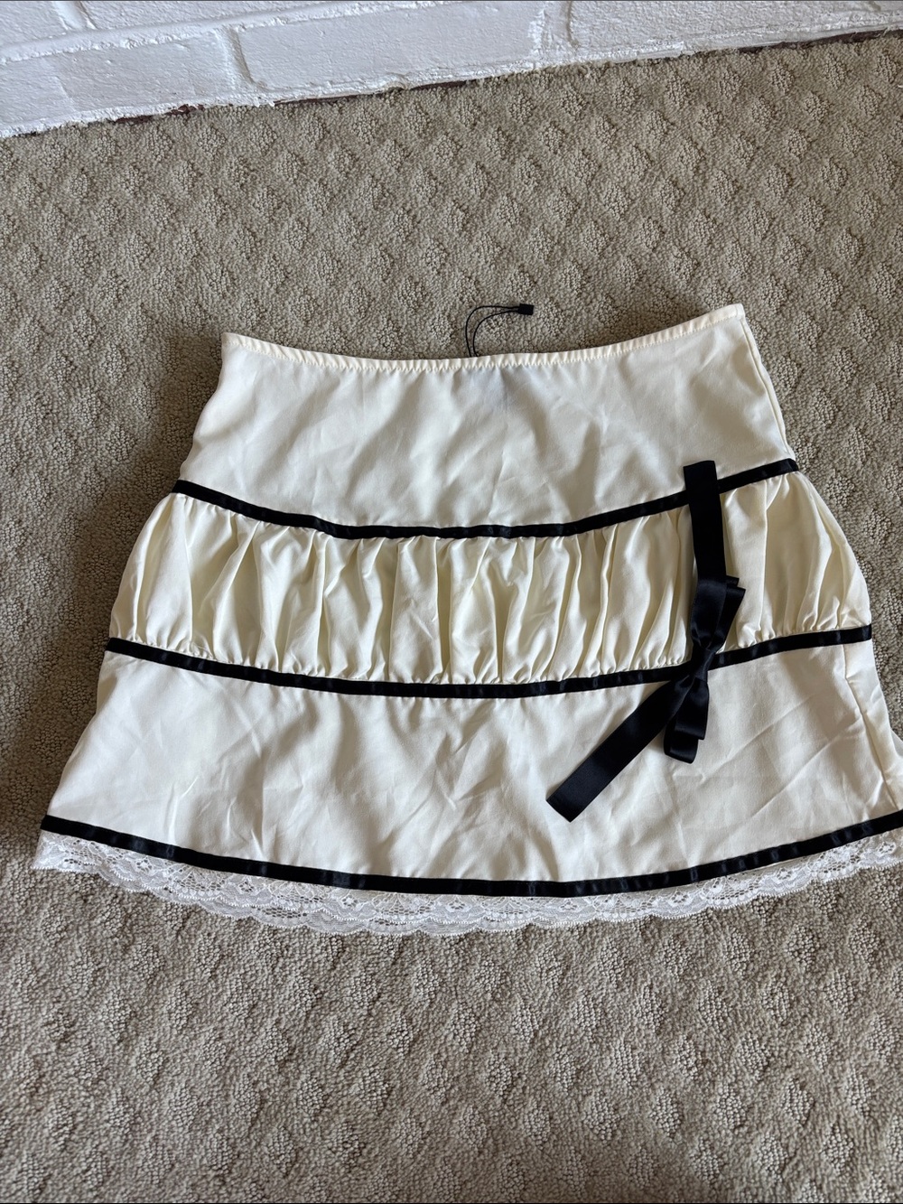 PrettyLittleThing Cream Mini Skirt with Black Trim & Bow Accent